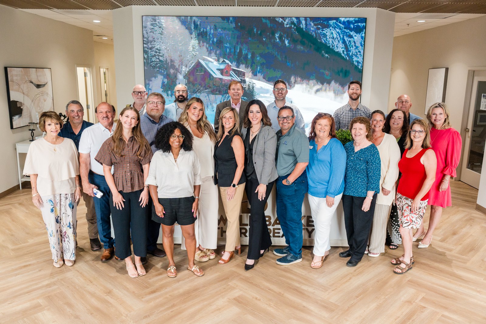 A brokerage team photographed together inside their office