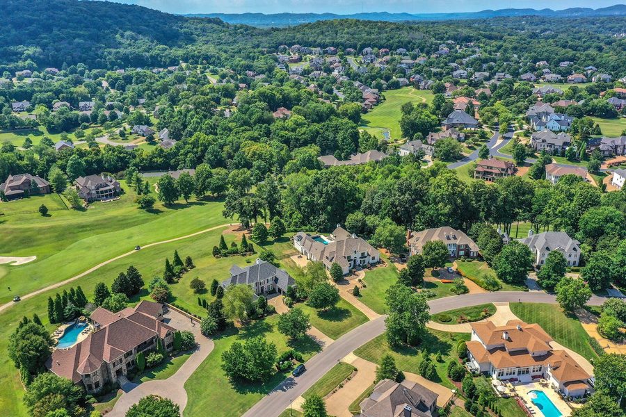 Aerial view over a golf course neighbourhood of large homes